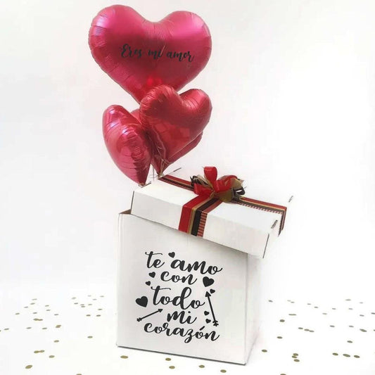 Caja Sorpresa BoxDeluxe: Explosión de Amor con 3 Globos en Forma de Corazón y Gominolas, decorada con cintas y un mensaje romántico, ideal para San Valentín.